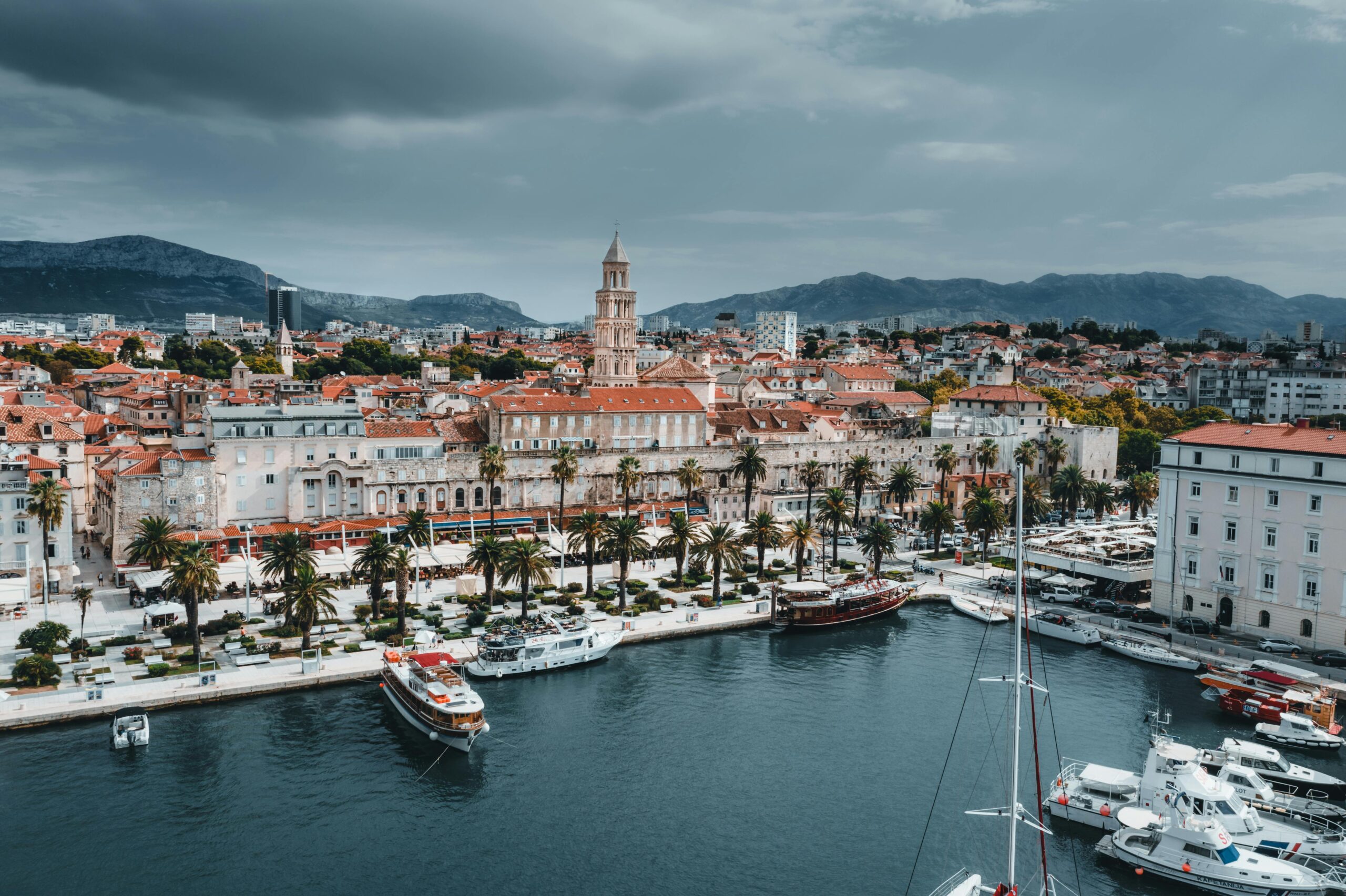 Stunning aerial view of Split's waterfront showcasing boats, buildings, and iconic bell tower.